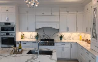 Quartz counter-top white shaker kitchen cabinets